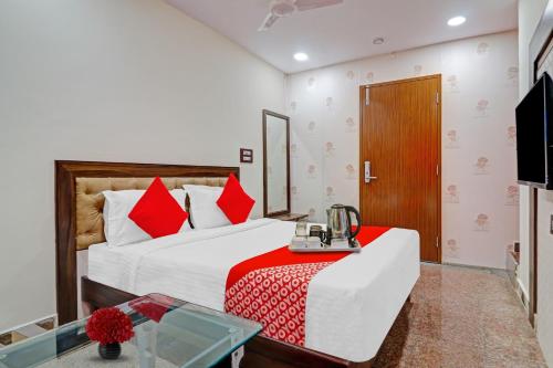 a hotel room with a bed and a television at Heavens Inn Near Rasoolpura metro station in Hyderabad