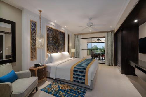 a bedroom with a bed and a couch and a tv at Marriott's Mai Khao Beach - Phuket in Mai Khao Beach