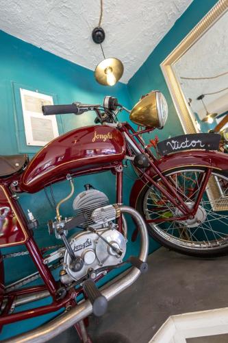 a red motorcycle is parked in a room at Les Pins Blancs en Provence in Le Muy