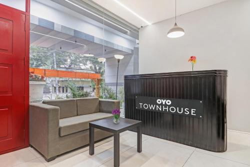 a couch and a table in a room with a window at Townhouse Ameerpet in Ameerpet