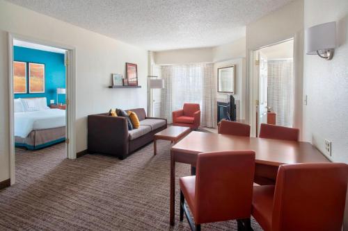 a hotel room with a dining table and a living room at Residence Inn Long Island Hauppauge/Islandia in Hauppauge