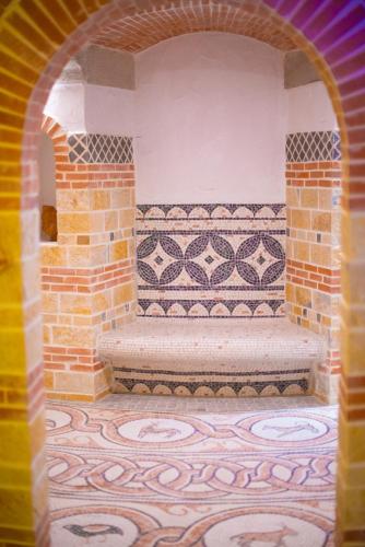 an archway with a bench in a room at Bougainvill Sunset Villa in Sarandë