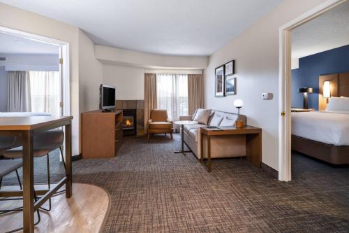 a hotel room with a bed and a couch at Residence Inn Austin South in Austin