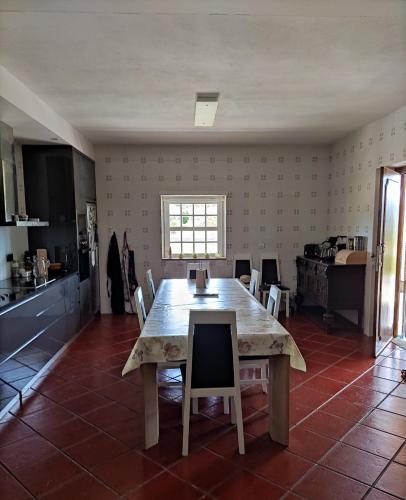 a kitchen with a large wooden table in a room at Quinta da Paixão - Bed & Breakfast in Pedraça