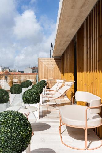 a row of chairs and tables on a roof at LUSTER Hotel in Lisbon