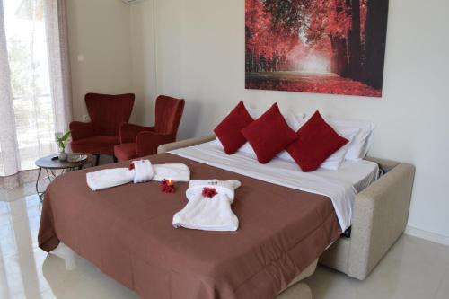 a hotel room with a bed with towels on it at Studio Holiday Kalamata 2 in Kalamata