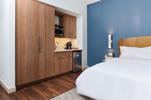 a bedroom with a large bed and a wooden cabinet at Element Chattanooga East in Chattanooga