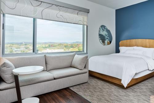 a bedroom with a bed and a couch at Element Chattanooga East in Chattanooga
