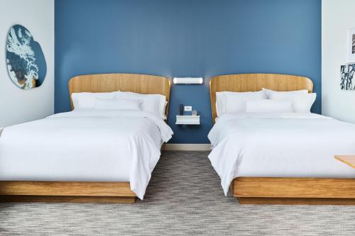 two beds in a room with blue walls at Element Chattanooga East in Chattanooga