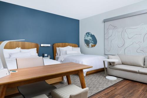 a room with two beds and a table and chairs at Element Chattanooga East in Chattanooga