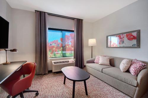 a living room with a couch and a window at Fairfield Inn & Suites Lancaster Palmdale in Lancaster
