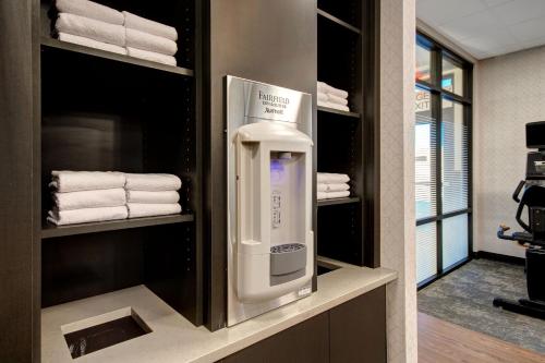 a towel dispenser in a bathroom with towels at Fairfield Inn & Suites Lancaster Palmdale in Lancaster