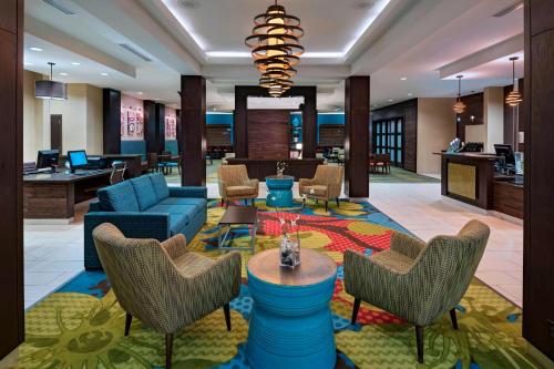 a lobby of a hotel with chairs and tables at Fairfield Inn and Suites by Marriott Austin Northwest/Research Blvd in Austin