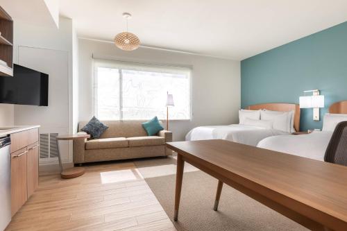 a hotel room with a bed and a couch at Element Houston Katy in Katy