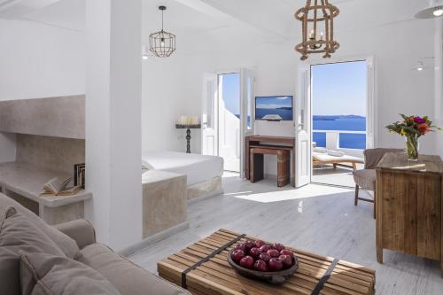 a living room with a couch and a table at White Pearl Villas in Oia