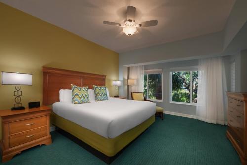 a bedroom with a large bed and a window at Marriott's Harbour Point and Sunset Pointe at Shelter Cove in Hilton Head Island