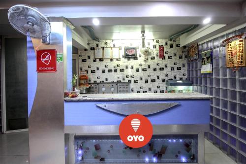 a counter in a kitchen with a fan at Hotel O Liberty in Ahmedabad
