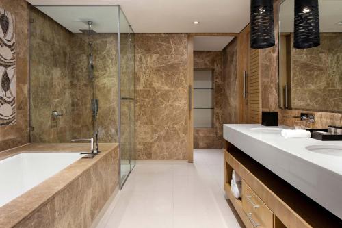 a bathroom with two sinks and a shower at Sheraton Lagos Hotel in Lagos
