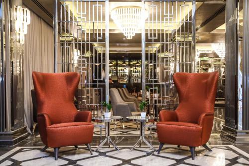 a lobby with two chairs and a table at Iris Hotel Baku in Baku