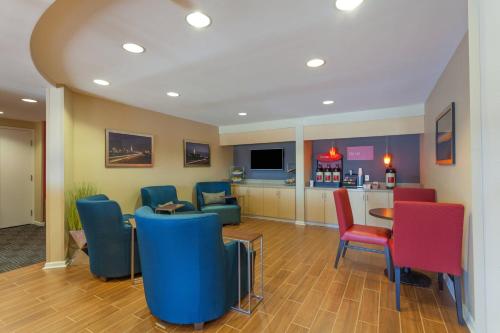 a waiting room with colorful chairs and a table at TownePlace Suites Huntsville in Huntsville