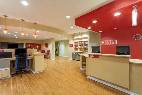 a lobby of a store with desks and chairs at TownePlace Suites Huntsville in Huntsville
