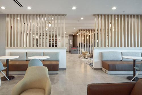 a lobby with tables and couches and chairs at TownePlace Suites by Marriott Chattanooga South, East Ridge in Chattanooga