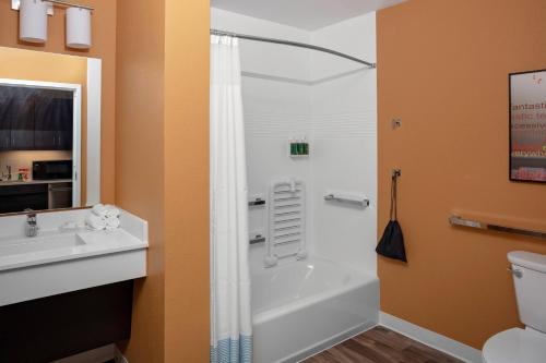 a bathroom with a tub and a sink and a toilet at TownePlace Suites by Marriott Gainesville in Gainesville