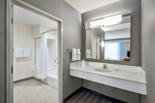 a bathroom with a sink and a mirror at Courtyard by Marriott Nashville Green Hills in Nashville