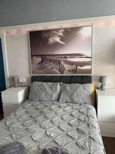 a bedroom with a bed with a large picture on the wall at The Woodleigh family hotel in Blackpool