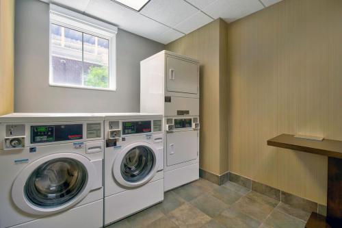 a laundry room with two washing machines and a window at Courtyard by Marriott Nashville Green Hills in Nashville