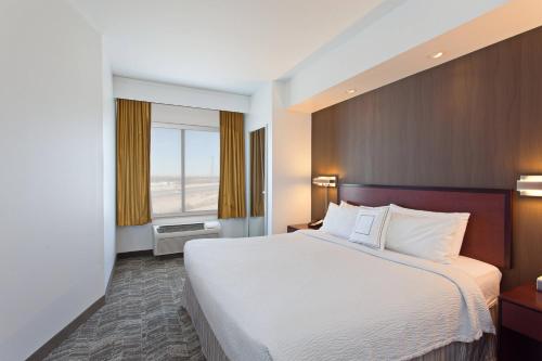a hotel room with a large bed and a window at SpringHill Suites by Marriott El Paso in El Paso