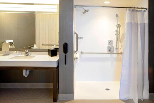 a bathroom with a shower and a sink at Courtyard by Marriott Muncie at Horizon Convention Center in Muncie