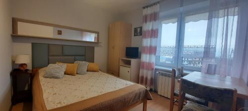a bedroom with a bed and a large window at U Wojtaszka in Mizerna