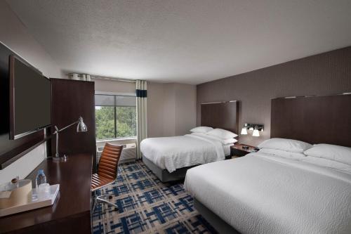 a hotel room with two beds and a window at Four Points by Sheraton Charlotte - Lake Norman in Huntersville