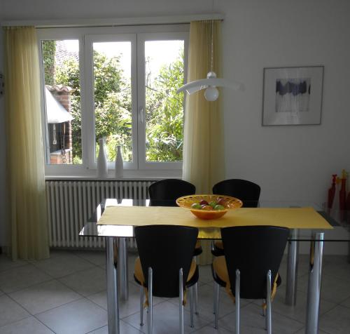 a dining room table with chairs and a bowl on it at Casa Solaria in Gordola