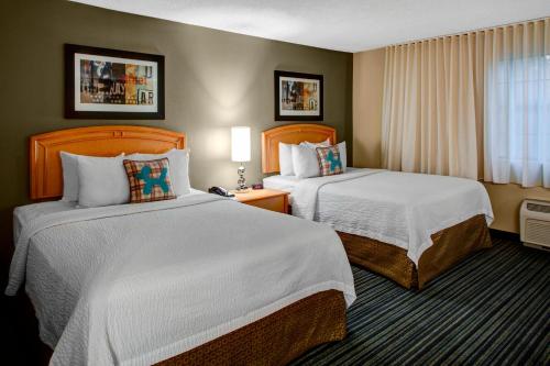 a hotel room with two beds and a window at TownePlace Suites Atlanta Buckhead in Atlanta