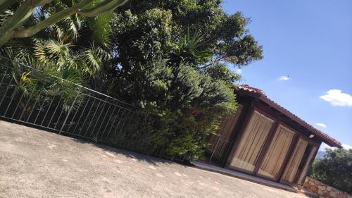a fence in front of a building with trees at Villa in vetro in Castellammare del Golfo