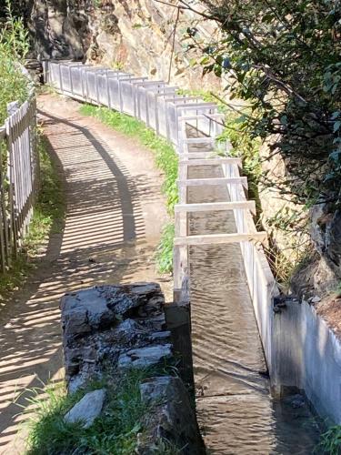 a wooden path on a hill with a fence at Val D’Illiez mountain apartment. in Val dʼIlliez