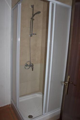 a shower with a glass door in a bathroom at Desert Escapes in Tabernas