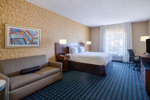 a hotel room with a bed and a couch at Fairfield Inn & Suites by Marriott Denver Aurora/Medical Center in Aurora