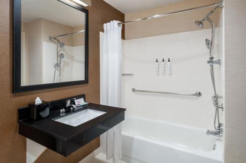 a bathroom with a black sink and a shower at Fairfield Inn & Suites by Marriott Denver Aurora/Medical Center in Aurora