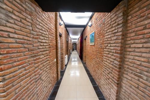 an alley between two large red brick walls at Tiflis Hotel in Tbilisi City