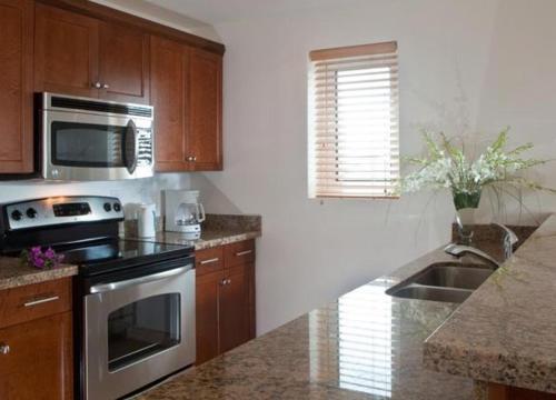 a kitchen with a stove and a sink at Hotel La Vista Azul in Turtle Cove