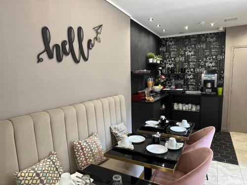 a dining room with a table and chairs and a restaurant at Hotel Agenor in Paris