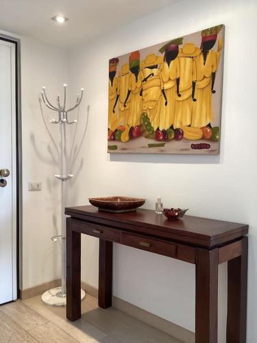 a table in a room with a painting on the wall at Diego's Apartment - Monza Park in Biassono
