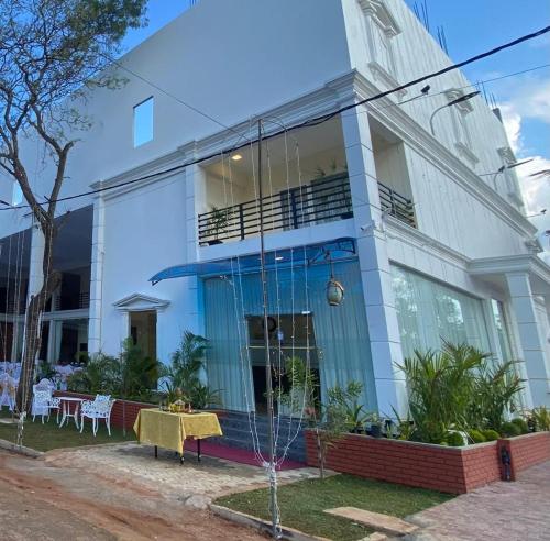 a white building with a table in front of it at Hotel NorthWay in Vavuniya