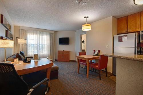 a hotel room with a kitchen and a living room at Residence Inn by Marriott Atlantic City Airport Egg Harbor Township in Egg Harbor Township
