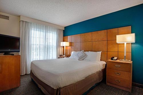 a bedroom with a large bed and a blue wall at Residence Inn by Marriott Atlantic City Airport Egg Harbor Township in Egg Harbor Township