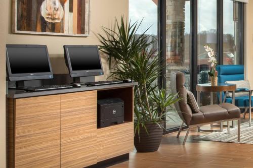 a desk with two computer monitors on top of it at TownePlace Suites by Marriott Nashville Smyrna in Smyrna