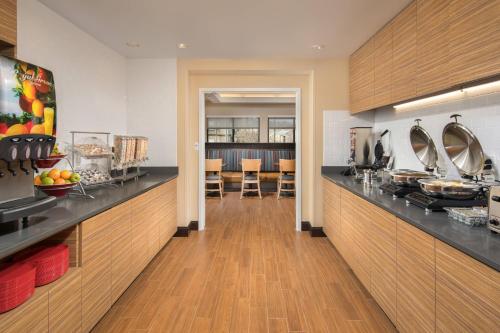 a kitchen with a counter and a dining room at TownePlace Suites by Marriott Nashville Smyrna in Smyrna